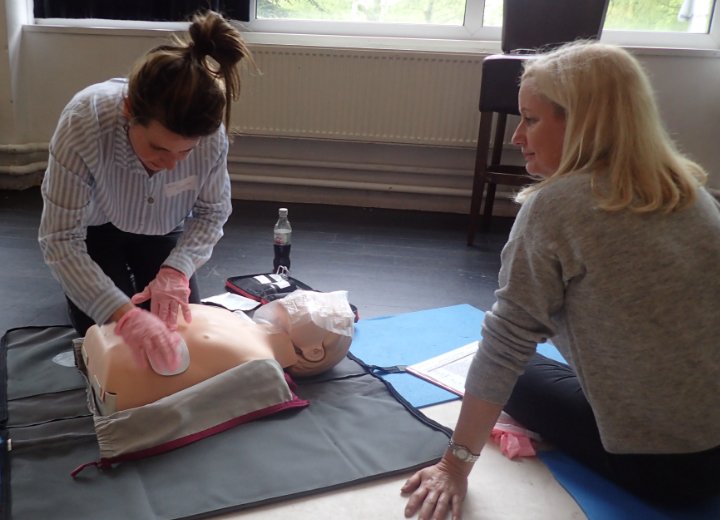 Delegates working on Annie First Aid Doll